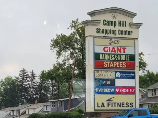 A sign shows that Mid State Baths is located in the Camp Hill Shopping Center with other well-known stores.