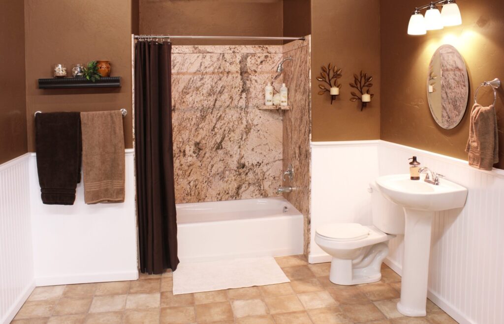 This bathroom by Mid State Baths feels clean and welcoming with updated walls, new fixtures, and a modern shower area.