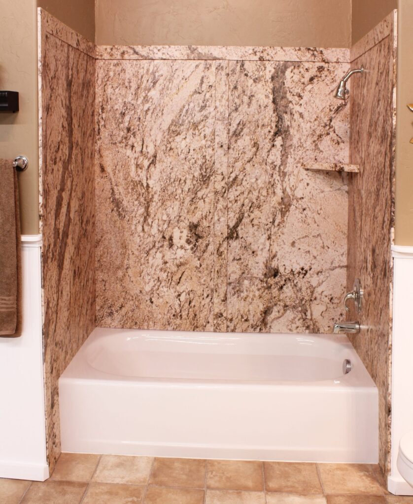 A new bathroom with a granite-style shower and clean tub from Mid State Baths shows how a remodel can make your space look fresh.