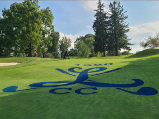 Golfers enjoy a game near a country club logo with the year 1920, making it a nice place to talk about Mid State Baths remodeling or shower updates.