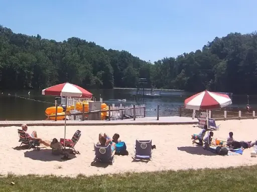 People enjoy a sunny day at the lake, relaxing and swimming. Mid State Baths provides expert shower refinishing in Carlisle nearby.