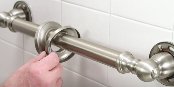 Someone from Mid State Baths adds a grab bar to make the bathroom safer during a remodel.